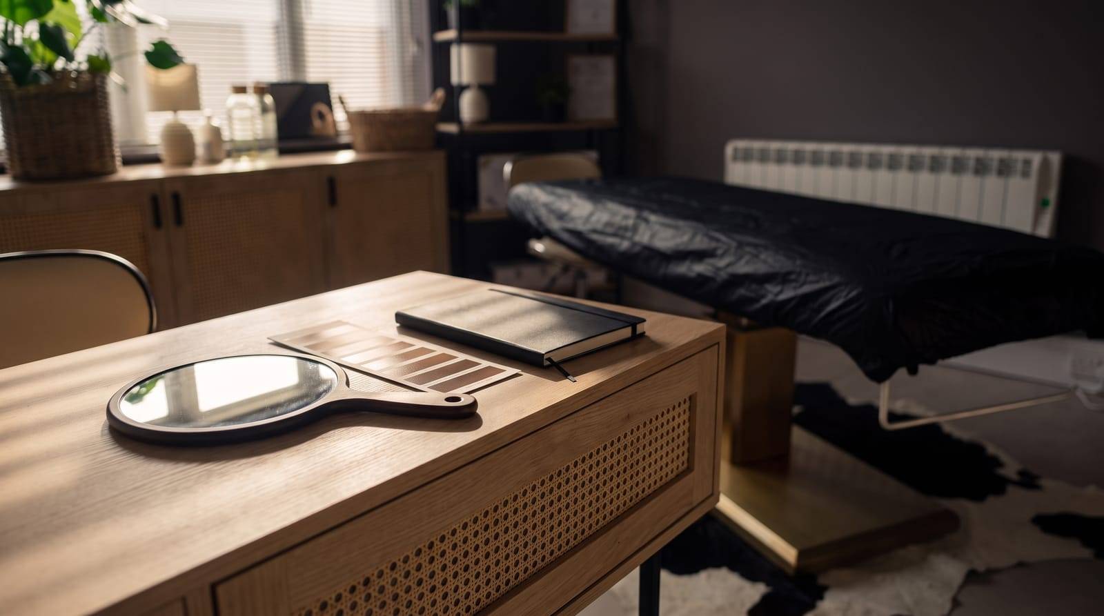 A round hand mirror, a graded shade card and a closed notebook on the consultation desk at Kennedy SMP Studio in Haverhill, the calm seat where the honest options for reducing a scar are talked through